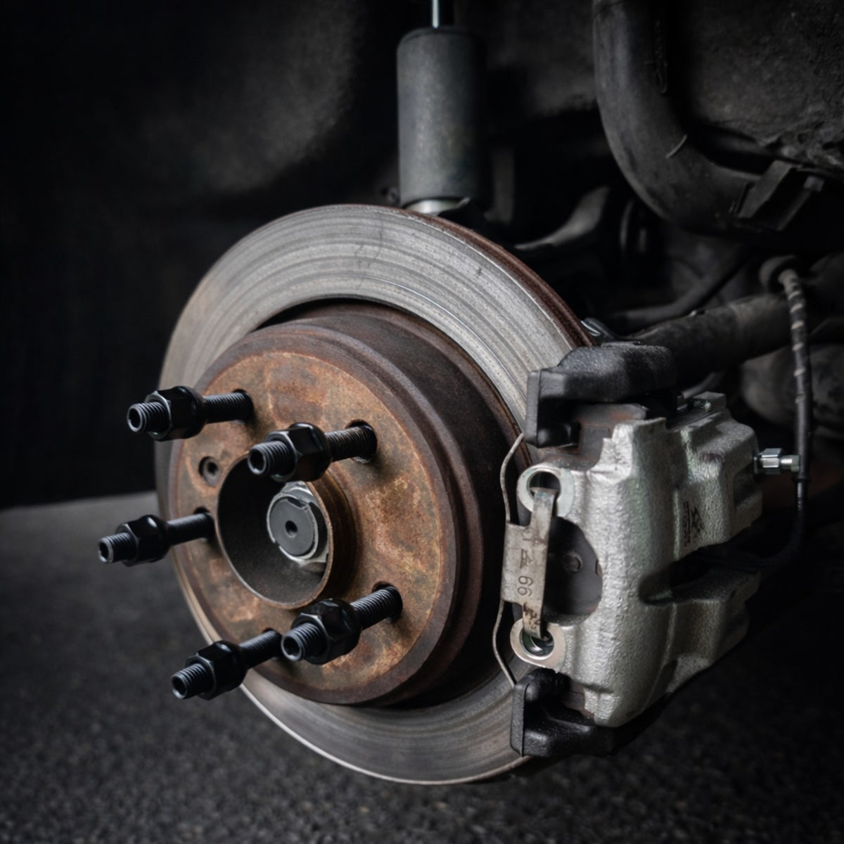 Black wheel studs and open-ended black nuts fitted to a BMW hub with the wheel removed